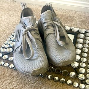Mens size 7, Women’s size 9, Grey Adidas NMD athletic shoes.